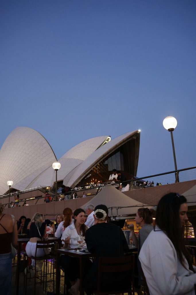 People dining with sydney opera house in background