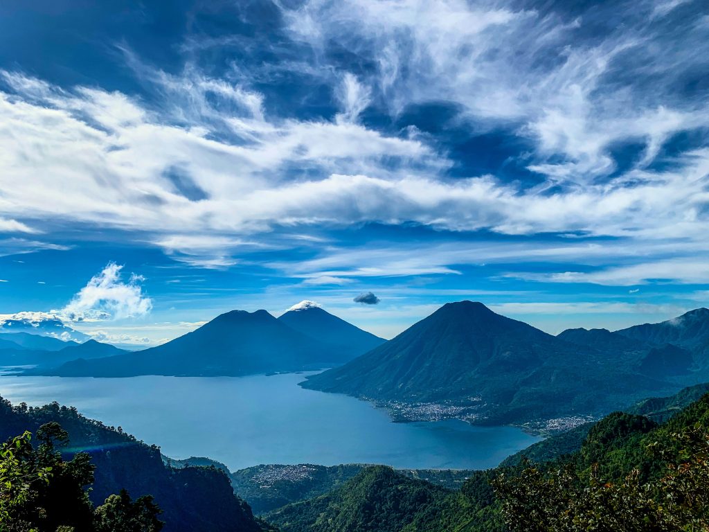 green mountains under white clouds and blue sky during daytime