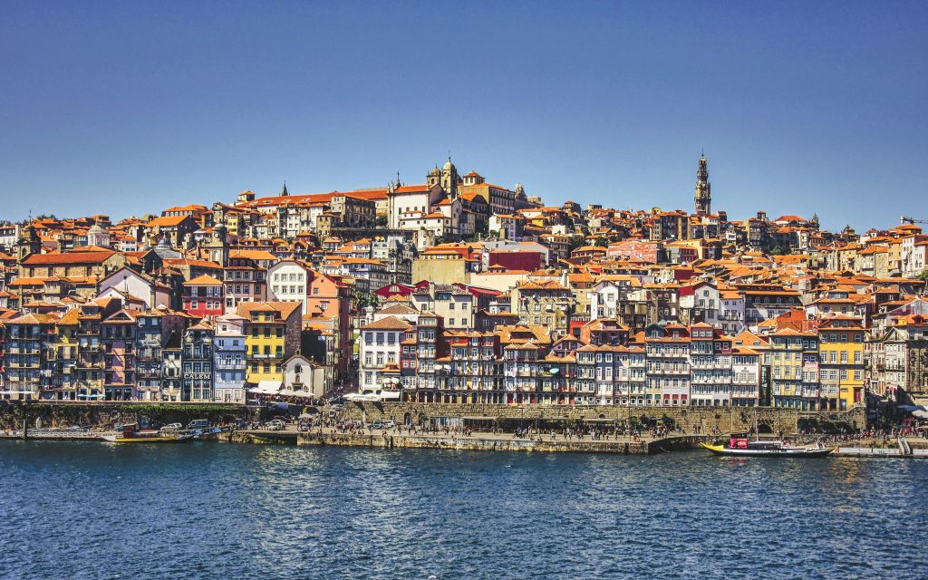 city buildings near body of water during daytime