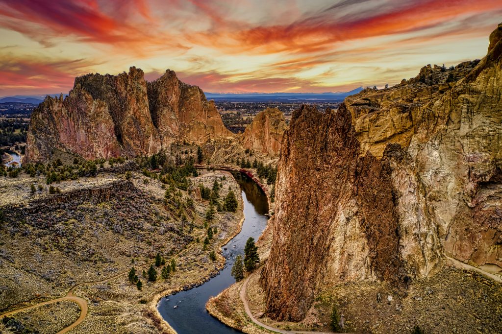 river between brown rocky mountains during sunset