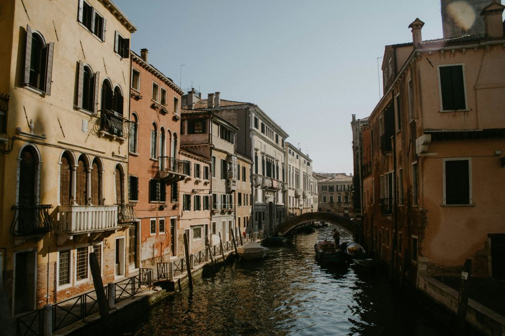 river between concrete buildings during daytime