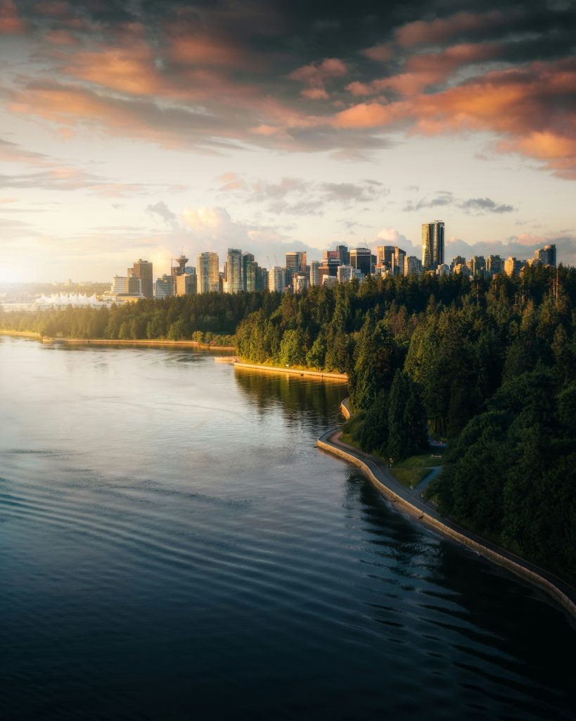 a view of a city and a lake at sunset
