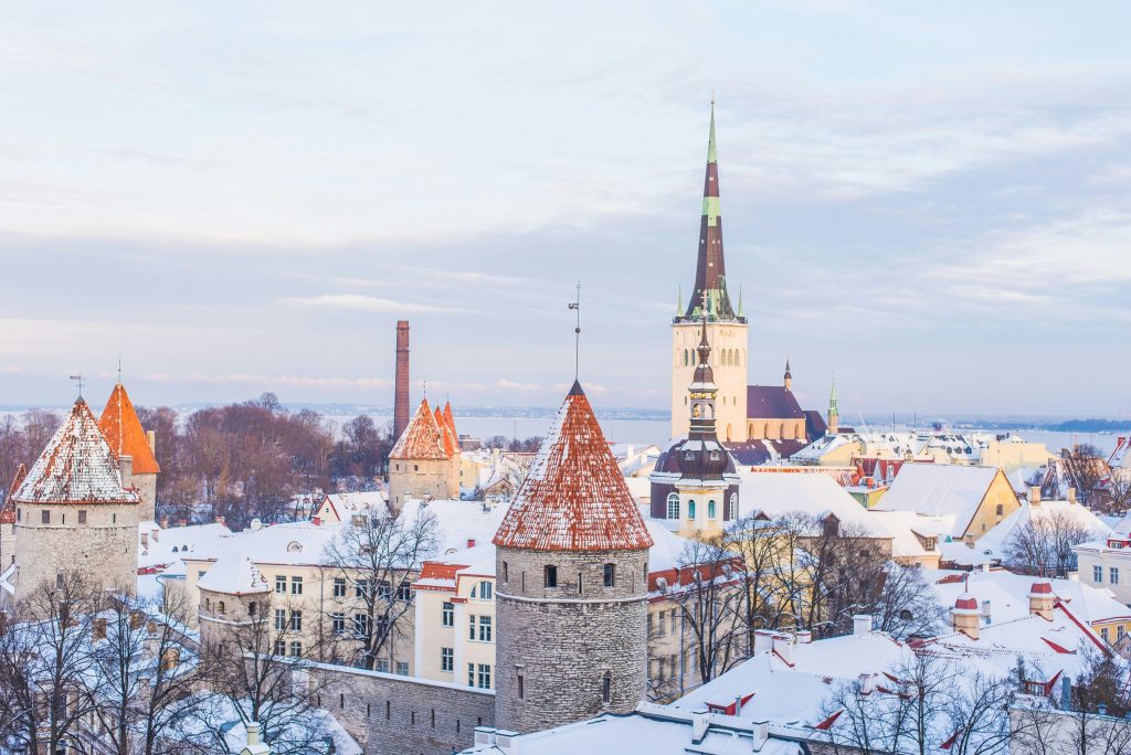 snow covered brown, white, and gray concrete castle under cloudy skies