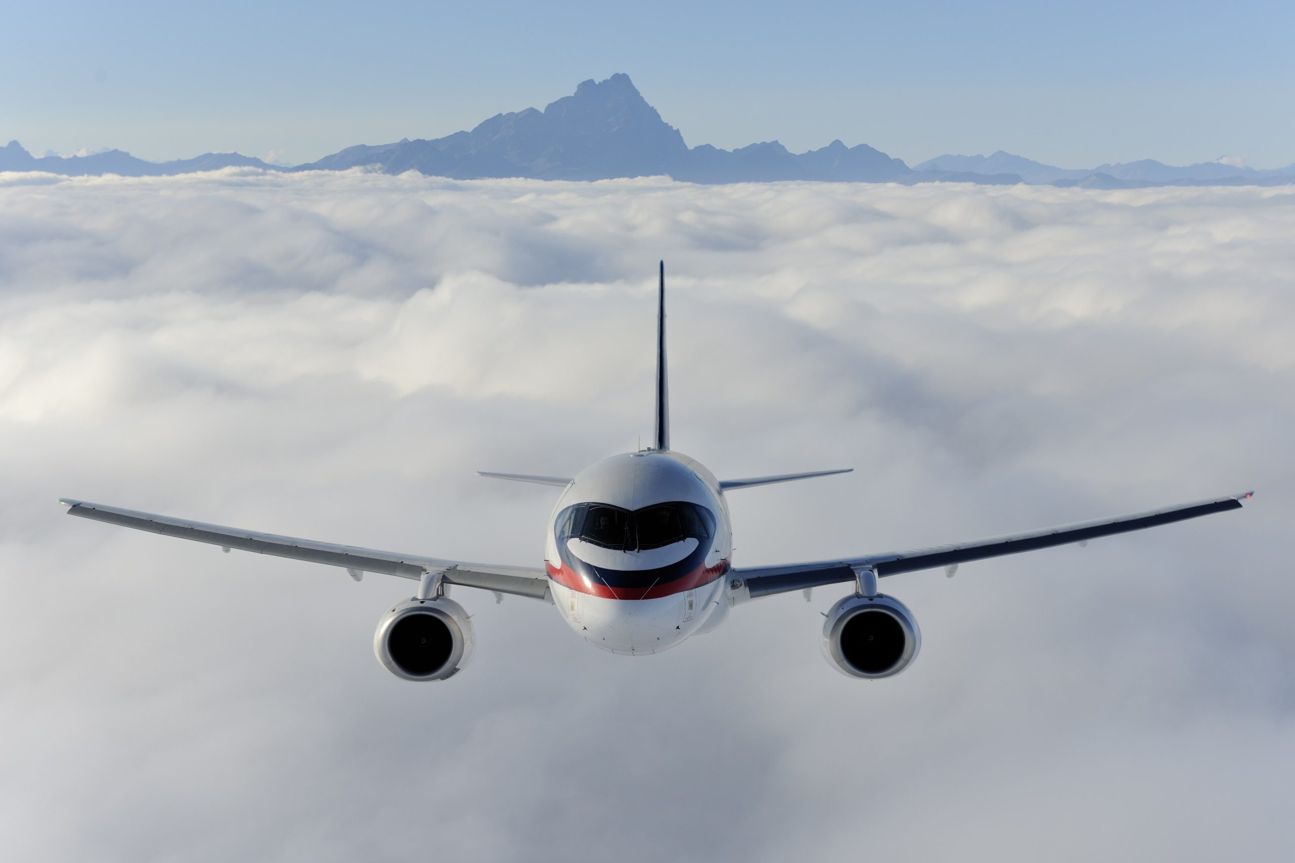 An airliner flying above the clouds