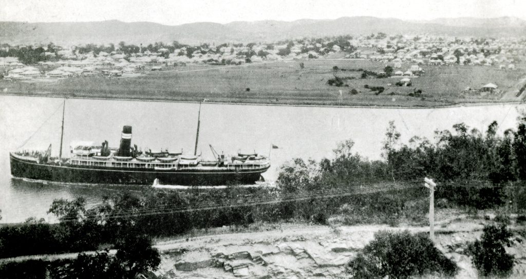 a view of a city and a lake with boats in the water
