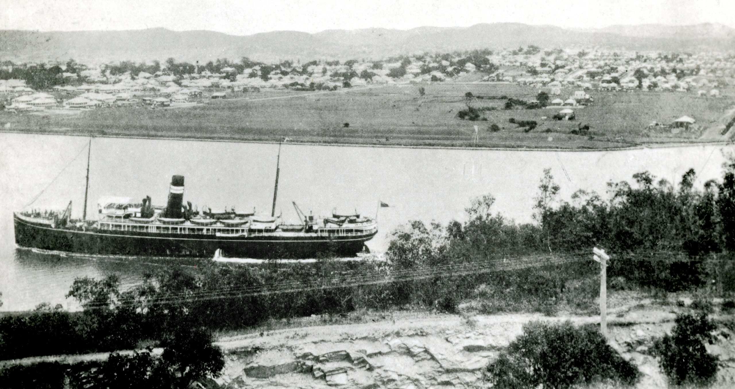 a view of a city and a lake with boats in the water